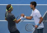 Tennis - Australian Open - Melbourne Park, Melbourne, Australia - 19/1/17 Uzbekistan's Denis Istomin shakes hands after winning his Men's singles second round match against Serbia's Novak Djokovic. REUTERS/Jason Reed