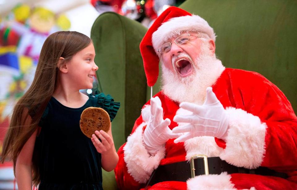 LeeLynn Bushong of Joint Base Lewis-McChord, clowns around with Santa at the South Hill Mall in Puyallup, Washington, on Wedeesday, Nov. 24, 2021.