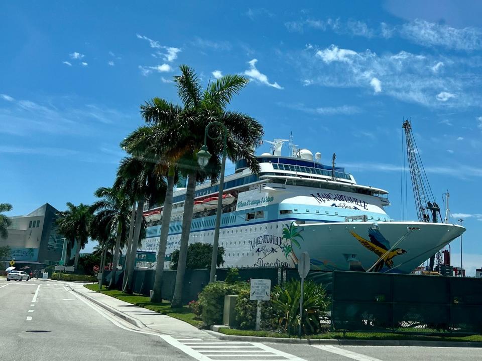 exterior of Margaritaville at Sea with palm trees in front of it