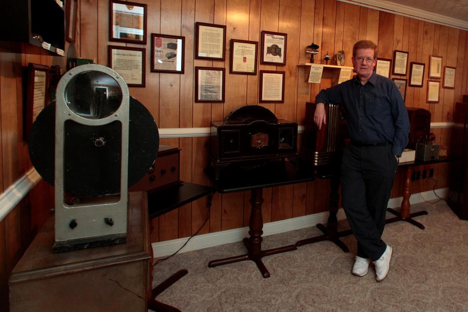 Don McLean poses at the Early Television Museum in Olde Hilliard Friday evening April 28, 2006 with a circa 1930 J.L. Baird 'Televisor' mechanical TV set produced in the United Kingdom before WWII. The TV sets of that era used rotating mirrors and a vacuum tube to produce an image.