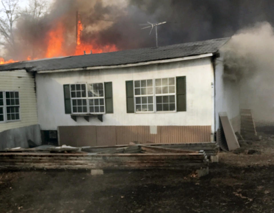 In this Jan. 11, 2017, photo provided by Sherman Hiatt, a wildfire triggered when a pile of chicken manure caught fire in a barn threatens property near Charleston, Ark. Agriculture experts are warning farmers to make sure their waste piles don't grow too high because the can catch fire through spontaneous combustion. (AP Photo/Sherman Hiatt)