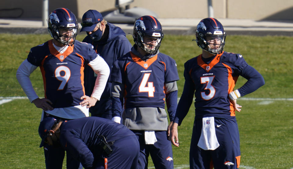 Denver Broncos quarterbacks Drew Lock, Brett Rypien and Jeff Driskel, from right, watch during the NFL football team's practice Wednesday, Nov. 11, 2020, in Englewood, Colo. (AP Photo/David Zalubowski)