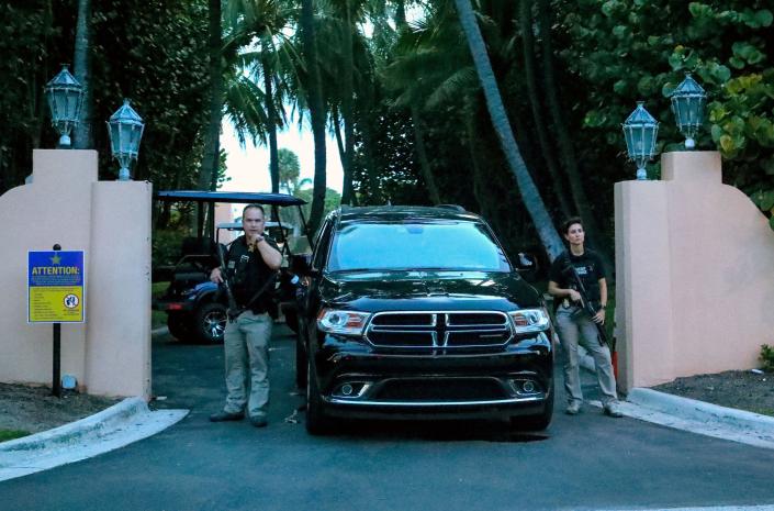 Secret service agents stand at the gate of Mar-a-Lago after the FBI issued warrants Monday.
