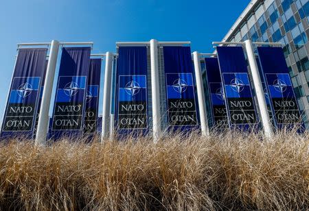 Banners displaying the NATO logo are placed at the entrance of new NATO headquarters during the move to the new building, in Brussels, Belgium April 19, 2018. REUTERS/Yves Herman/Files