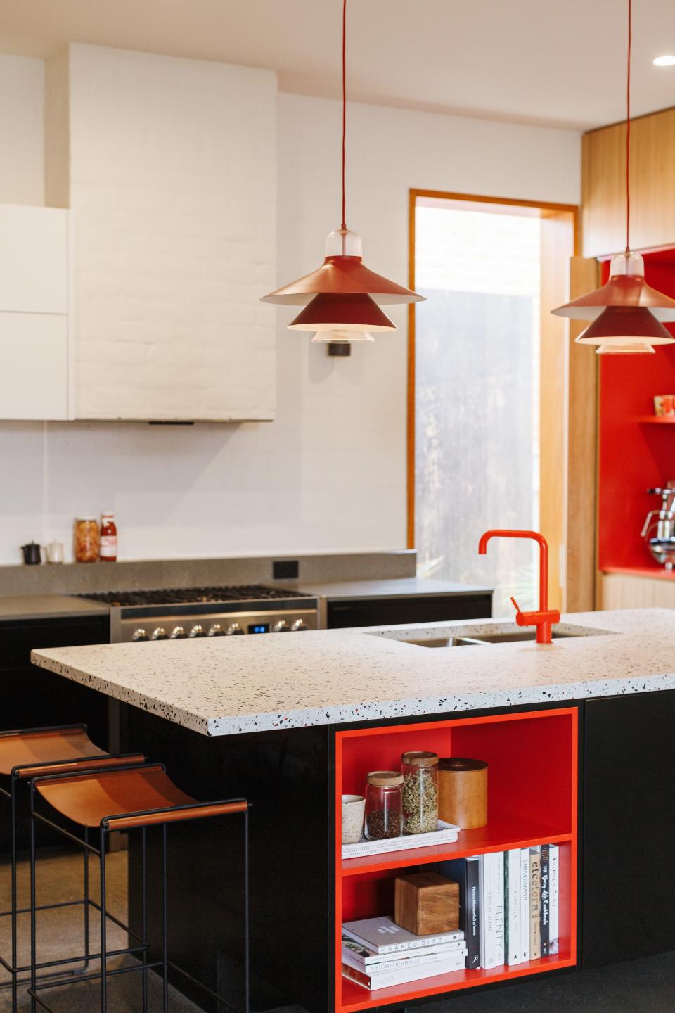Pops of red were one of the most important elements of the design, especially in the kitchen. Kate wanted it to be a playful contrast to the natural wood details, even when it came to the small island nook.