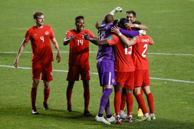 Canada players celebrate a 3-0 win over Haiti in the second leg of a World Cup qualifying match on Tuesday. (Kamil Krzaczynski/The Associated Press - image credit)