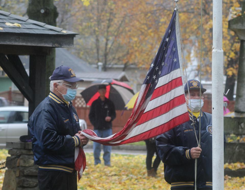 Wellsville American Legion Post 702 members prepare to raise the flag during a past ceremony in Veterans Memorial Park.