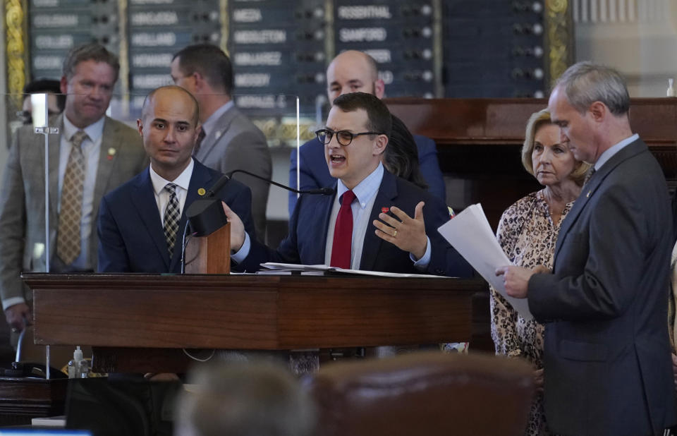 Rep. Briscoe Cain, R-Houston, center, stands with co-sponsors as he answers questions and speaks in favor of HB 6, an election bill, in the House Chamber at the Texas Capitol in Austin, Texas, Thursday, May 6, 2021. (AP Photo/Eric Gay)