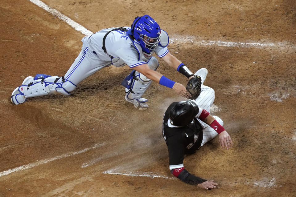 Toronto Blue Jays catcher Reese McGuire tags out Chicago White Sox's Yasmani Grandal at home during the fourth inning of a baseball game Wednesday, June 9, 2021, in Chicago. (AP Photo/Charles Rex Arbogast)