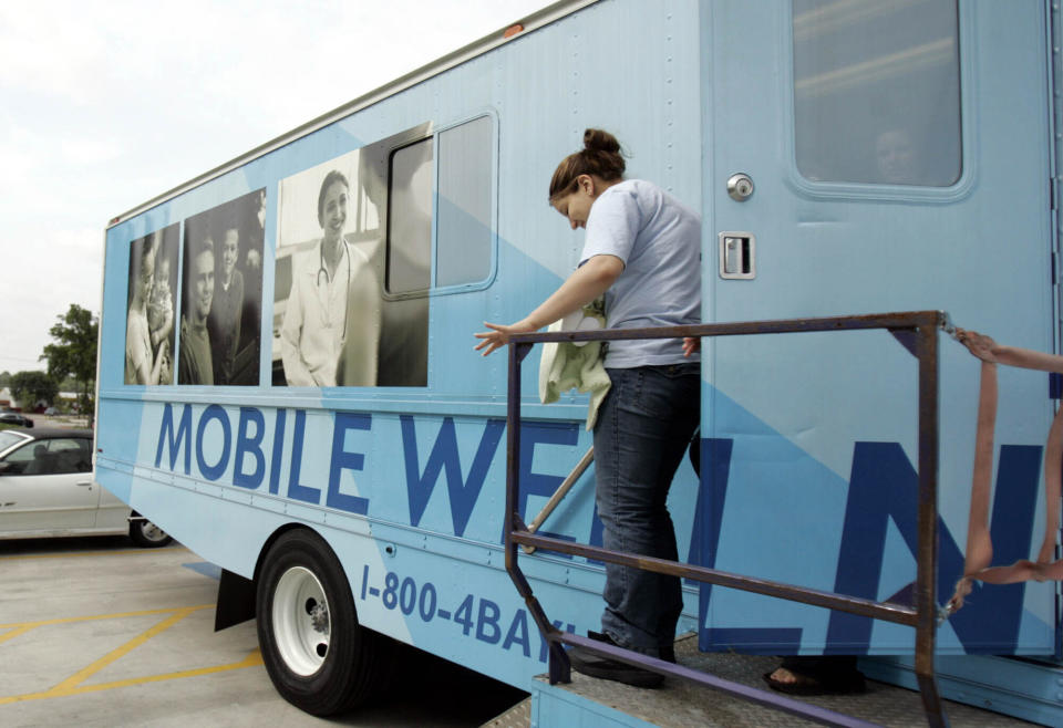 FILE - Leslie Rosas, 15, leaves the mobile health clinic with her one-month-old daughter Cielo Angela Carrizalez after their checkup at the mobile health clinic in Garland, Texas, on April 11, 2006. The clinic is just one way of helping teen mothers in Texas. States with some of the nation's strictest abortion laws are also some of the hardest places to have and raise a healthy child, especially for the poor, according to an analysis of federal data by The Associated Press. (AP Photo/LM Otero)