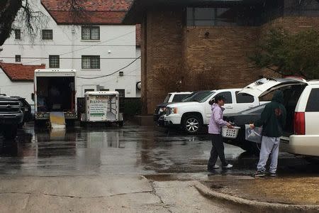 People load goods into moving trucks at the back of the Sigma Alpha Epsilon fraternity at the University of Oklahoma in Norman, Oklahoma, March 9, 2015. REUTERS/Heide Brandes