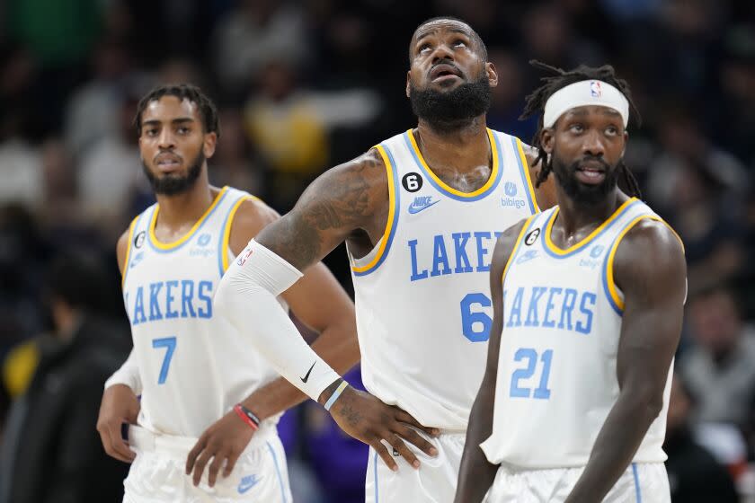 Los Angeles Lakers forward Troy Brown Jr. (7), forward LeBron James (6) and guard Patrick Beverley.