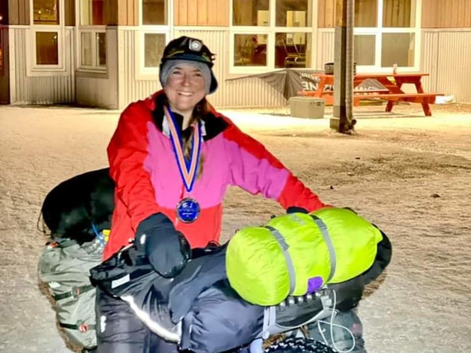 Jessie Gladish pushed her fat bike to the finish line, winning the 2022 Yukon Arctic Ultra endurance race around 4 a.m. Wednesday.  (Montane Yukon Artic Ultra/Facebook - image credit)