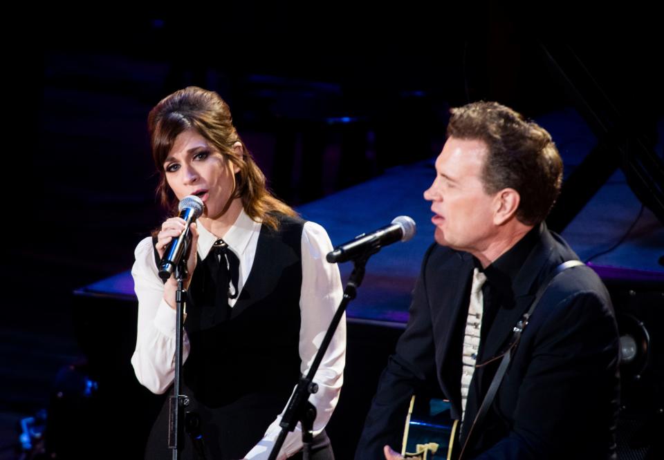 Nicole Atkins and Chris Isaak performs during a birthday celebration and belated memorial concert for songwriter John Prine at the Ryman Auditorium in Nashville , Tenn., Monday, Oct. 10, 2022.