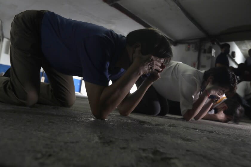 Taiwanese people take cover inside of a basement shelter during the Wanan air raid drill, in Taipei, Taiwan, Monday, July 25, 2022. Taiwan's capital staged air raid drills Monday and its military mobilized for routine defense exercises, coinciding with concerns over a forceful Chinese response to a possible visit to the island by U.S. Speaker of the House Nancy Pelosi. (AP Photo/Chiang Ying-ying)