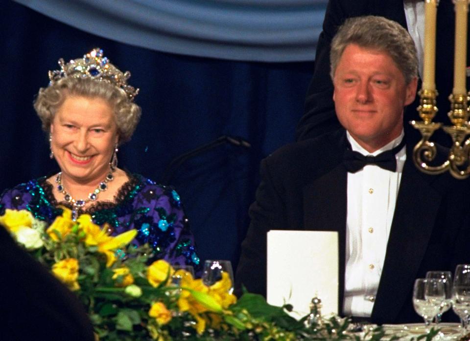 In this Saturday, June 4, 1994 file photo, Britain's Queen Elizabeth II smiles, as she sits alongside President Bill Clinton at a dinner in the Guildhall in Portsmouth, England, commemorating the 50th anniversary of D-Day.