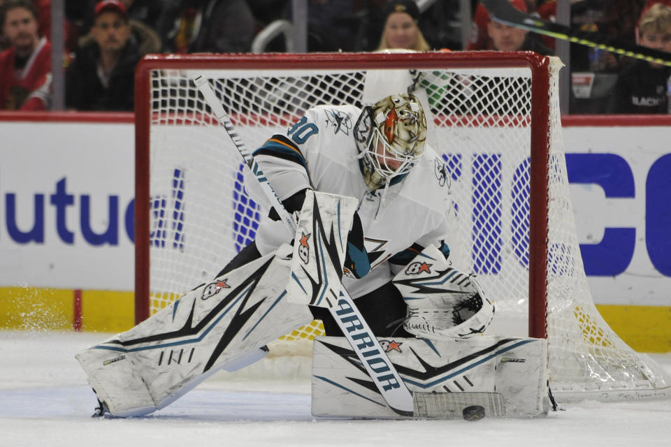 San Jose Sharks goalie Aaron Dell (30) makes a save during the second period of an NHL hockey game against the Chicago Blackhawks Wednesday, March 11, 2020, in Chicago. (AP Photo/Paul Beaty)