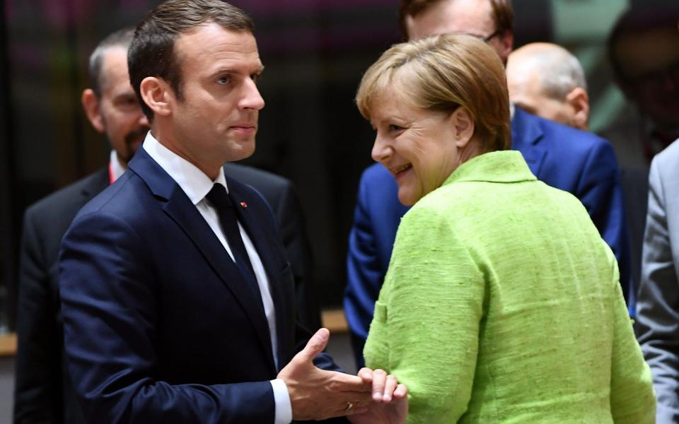French President Emmanuel Macron and German Chancellor Angela Merkel attend an European Council in Brussels, on June 22 - Credit:  EMMANUEL DUNAND/AFP