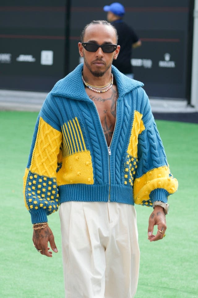 Seven-time world champion Lewis Hamilton arrives in the paddock on Thursday