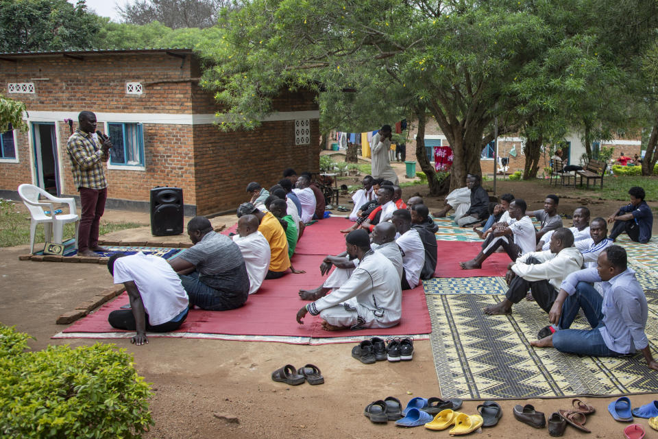 Men who were evacuated from Libya to Rwanda attend muslim prayers in the Gashora transit center for refugees and asylum-seekers, in the Bugesera district of Rwanda Friday, June 10, 2022. As Britain plans to send its first group of asylum-seekers to Rwanda amid outcries and legal challenges, some who came there from Libya under earlier arrangements with the United Nations say the new arrivals can expect a difficult time ahead. (AP Photo)