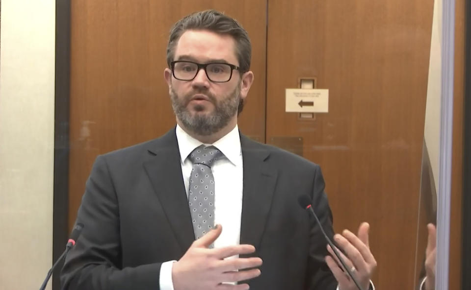 In this image from video, defense attorney Eric Nelson questions Minneapolis Police Officer Nicole Mackenzie as Hennepin County Judge Peter Cahill presides, Tuesday, April 13, 2021, in the trial of former Minneapolis police Officer Derek Chauvin at the Hennepin County Courthouse in Minneapolis, Minn. Chauvin is charged in the May 25, 2020 death of George Floyd. (Court TV via AP, Pool)