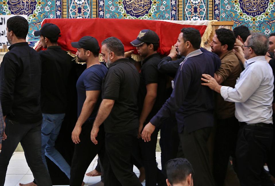 Mourners carry the flag-draped coffin of a protester killed during anti-government protesters during his funeral at the Imam Ali shrine in Najaf, Iraq, Saturday, Oct. 5, 2019. The spontaneous protests which started Tuesday in Baghdad and southern cities were sparked by endemic corruption and lack of jobs. Security responded with a harsh crackdown, leaving more than 70 killed. (AP Photo/Anmar Khalil)