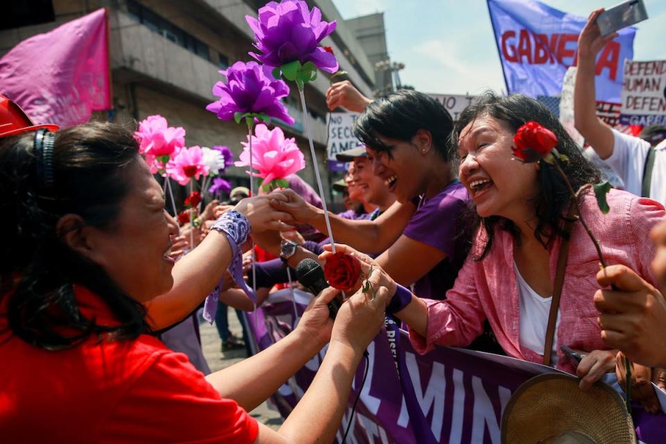 filipino women exchange flowers.JPG