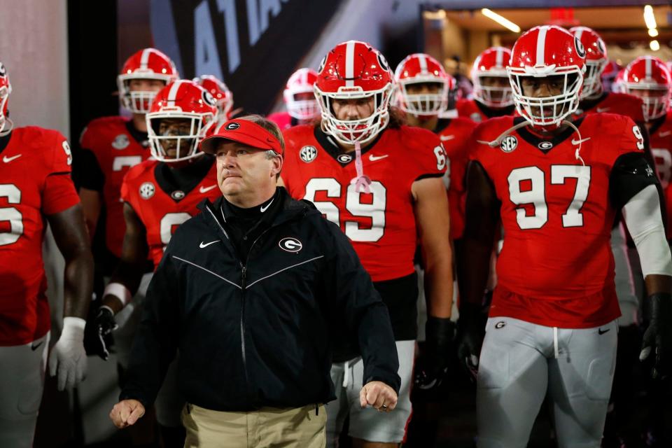 Georgia coach Kirby Smart lead the team onto the field to warm up before the start of a NCAA college football game against Ole Miss in Athens, Ga., on Saturday, Nov. 11, 2023.