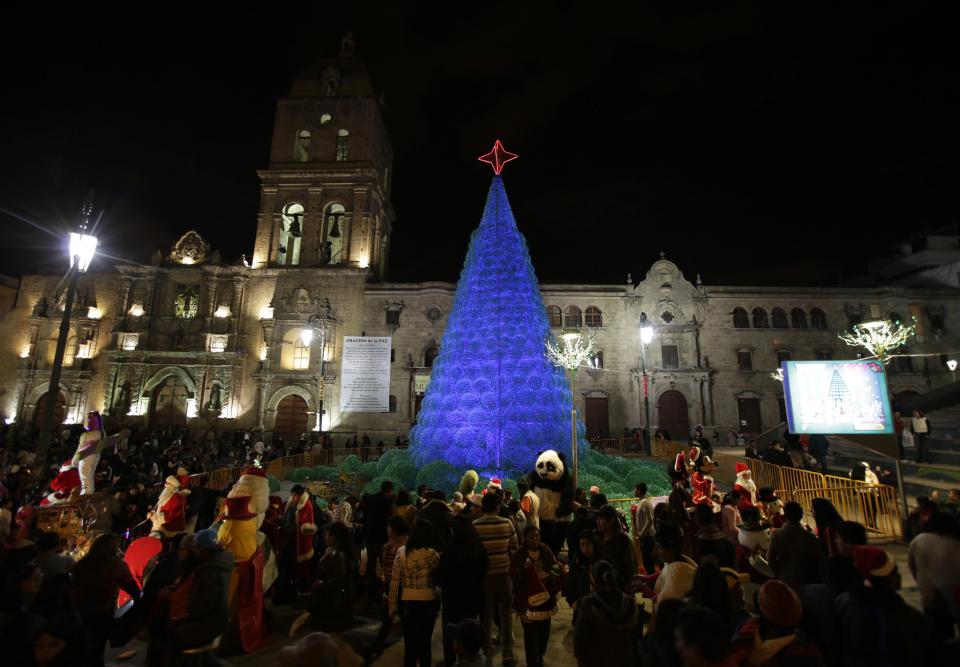 People gather at San Francisco Square in front of a Christmas tree, in La Paz