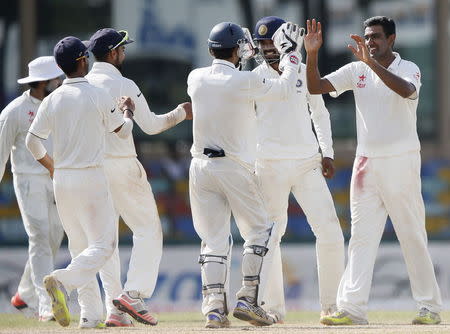 India's Ravichandran Ashwin (R) celebrates with his teammates after taking the catch to dismiss Sri Lanka's Dhammika Prasad (not pictured) during the final day of their third and final test cricket match in Colombo, September 1, 2015. REUTERS/Dinuka Liyanawatte