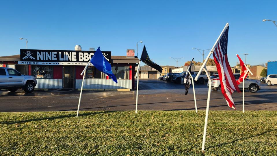 Military flags of all services greet customers at Nine Line BBQ on Hillside Road in Amarillo.