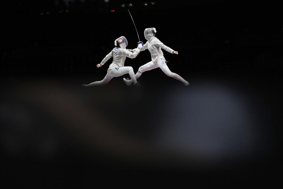 Cecilia Berder of France, left, and Sofia Pozdniakova of the Russian Olympic Committee compete in the women's Sabre team final competition at the 2020 Summer Olympics, Saturday, July 31, 2021, in Chiba, Japan. (AP Photo/Hassan Ammar)