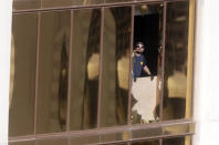 <p>Agents from the FBI use binoculars from the broken window where a gunman opened fire at the Mandalay Bay hotel, Wednesday, Oct. 4, 2017, in Las Vegas. (Photo: Gregory Bull/AP) </p>