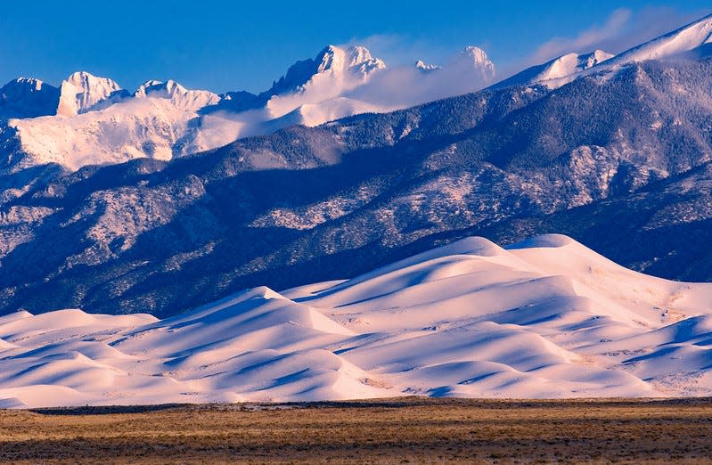 Spring snow covers the dunes at Great Sand Dunes National Park in March 2023.