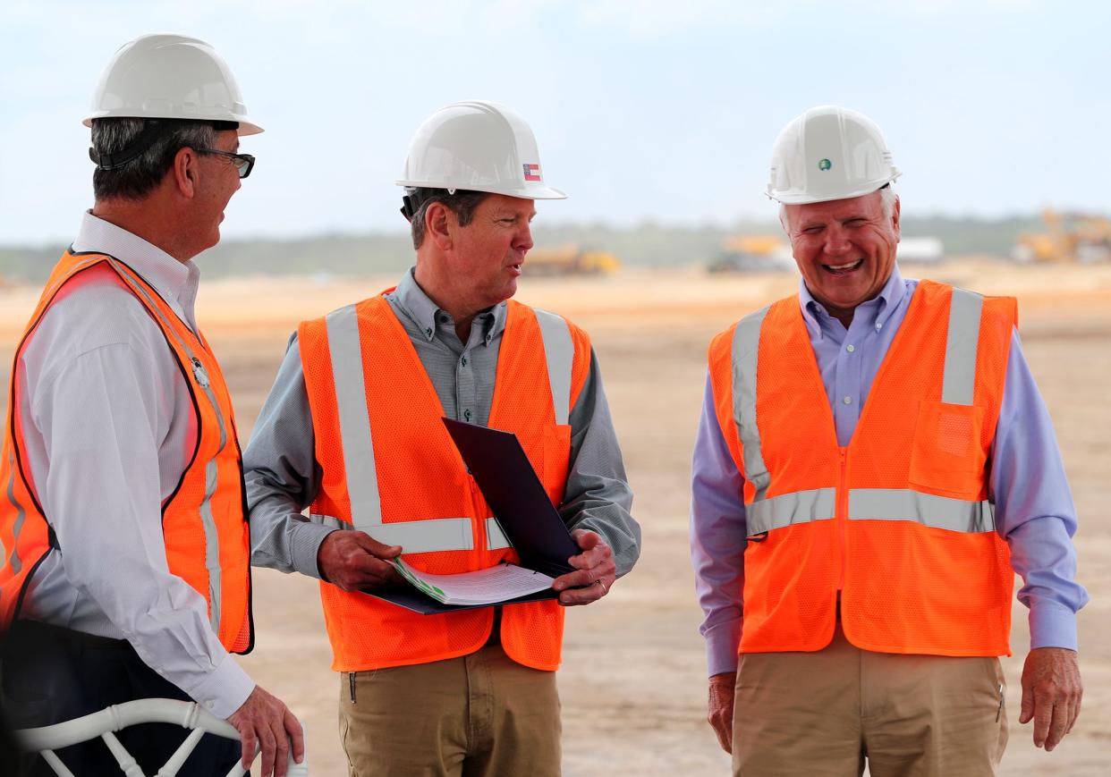 Georgia Governor Brian Kemp, center, talks with Speaker of the House Jon Burns, right, and Carter Infinger, JDA chairman, before signing two bills on Friday, May 5, 2023 at the future site of the Hyundai Meta Plant in Ellabell, Georgia.