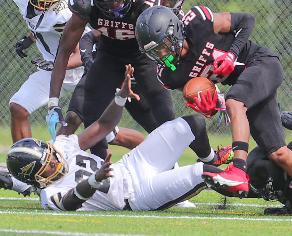 Buchtel's Jaeson Anderson scoops up a fumble by Warren Harding running back Ryan Powell at the goal line on Saturday in Akron.