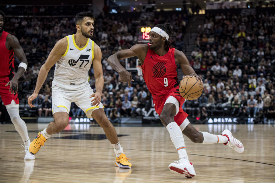 Portland Trail Blazers forward Jerami Grant (9) drives against Utah Jazz center Omer Yurtseven (77) during the first half of an NBA basketball game Saturday, Dec. 2, 2023, in Salt Lake City. (AP Photo/Isaac Hale)