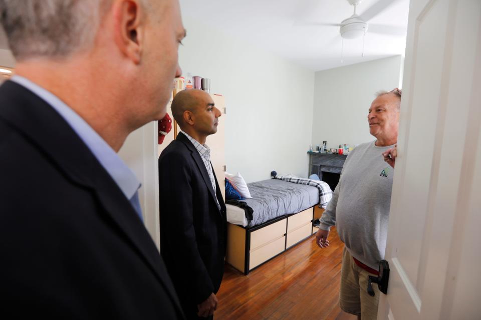 Massachusetts Veterans Services Secretary Jon Santiago speaks with house manager, Robert Frazier, during his visit to the Veterans Transition House in New Bedford.