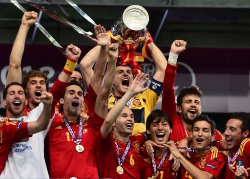 Spanish players celebrate with the trophy after winning the Euro 2012 football championships final match Spain vs Italy on July 1, at the Olympic Stadium in Kiev. By thrashing Italy 4-0 in Sunday's Euro 2012 final in Kiev, Spain staked a claim to the title of the greatest international team of all time