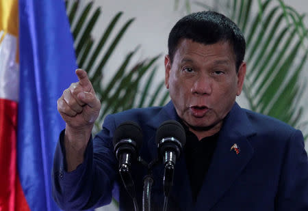 Philippine President Rodrigo Duterte interacts with reporters during a news conference upon his arrival from a four-day state visit in China at the Davao International Airport in Davao city, Philippines October 21, 2016. REUTERS/Lean Daval Jr.