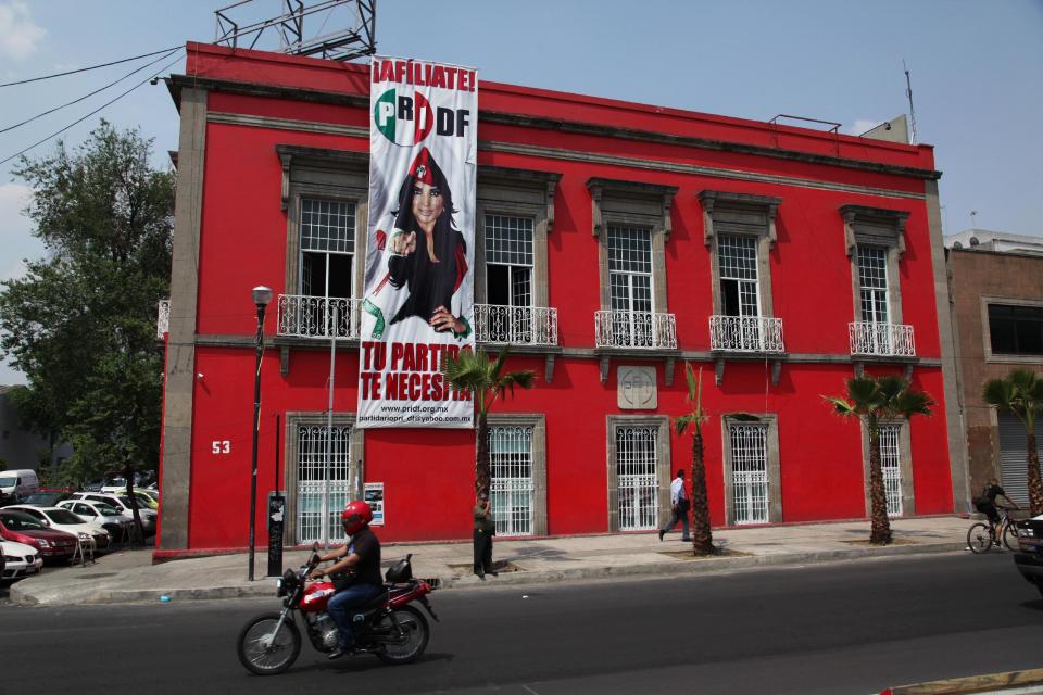 A sign promoting the Institutional Revolutionary Party (PRI) reads in Spanish "Sign up! Your party needs you." hangs on the PRI headquarters for Mexico City, Wednesday, April 2, 2014. Cuauhtemoc Gutierrez, local political chief from Mexico's ruling party, the PRI, is denying local press reports that his office hired women to have sex with him by placing them on party payrolls as secretaries or receptionists. The MVS radio station says an undercover reporter recorded recruiters telling potential hires they would have to have sex with their boss. (AP Photo/Marco Ugarte)