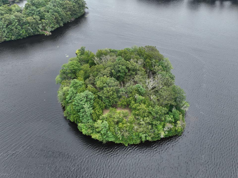 This aerial drone photo shows the island in Lake Sabbatia in Taunton, which residents say has been the site of loud parties particularly in July and early August of 2023.