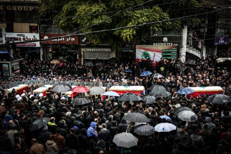 People carry the coffins of Lebanese civilians, who were killed in an Israeli drone strike on a building in the southern Lebanese village of Nabatieh, during their funeral procession. Seven civilians from the same family were killed when an Israeli drone attacked a building in Nabatieh on 14 February, targeting top pro-Iranian Hezbollah commander Ali al-Debs and four of his guards. Marwan Naamani/dpa
