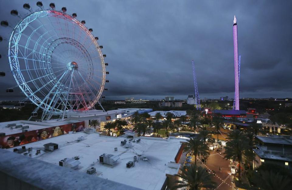 ICON Park attractions, The Wheel, left, Orlando SlingShot, middle, and Orlando FreeFall, right, in Orlando, Fla., on Thursday, March 24, 2022. (Stephen M. Dowell /Orlando Sentinel via AP)