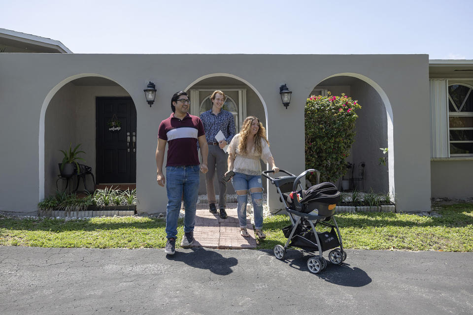 CUTLER BAY, FLORIDA - APRIL 20: Ryan Ratliff (C), Real Estate Sales Associate with Re/Max Advance Realty,  shows Ryan Paredes (L) and Ariadna Paredes a home for sale on April 20, 2023 in Cutler Bay, Florida. In a report by the National Association of Realtors, existing-home sales edged 2.4% lower in March to a seasonally adjusted annual rate of 4.44 million. In addition, sales declined 22.0% from one year ago.. (Photo by Joe Raedle/Getty Images)