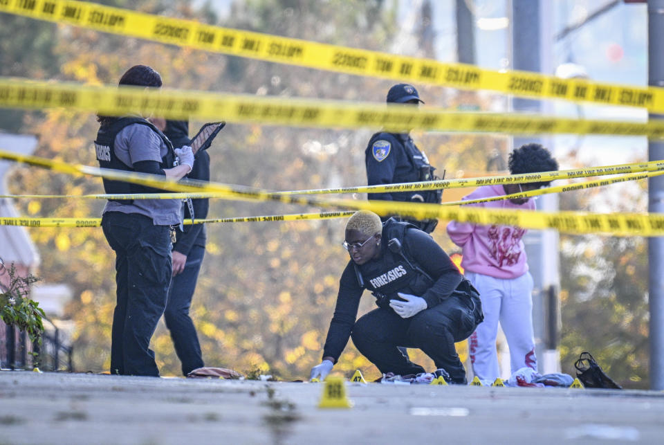 FILE - A Baltimore Police forensics technician documents the scene where a man was fatally shot by police, Tuesday, Nov. 7, 2023, in Baltimore. Maryland state prosecutors on Friday, Jan. 19, 2024, that four Baltimore police officers who fired three dozen shots at the armed man during a foot pursuit in November won’t face criminal charges. (Jerry Jackson/The Baltimore Sun via AP, File)