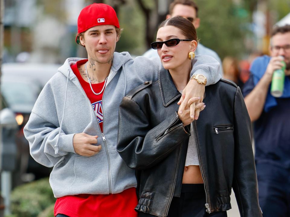 justin bieber walking down the street in LA with his arm around the shoulders of his wife hailey bieber