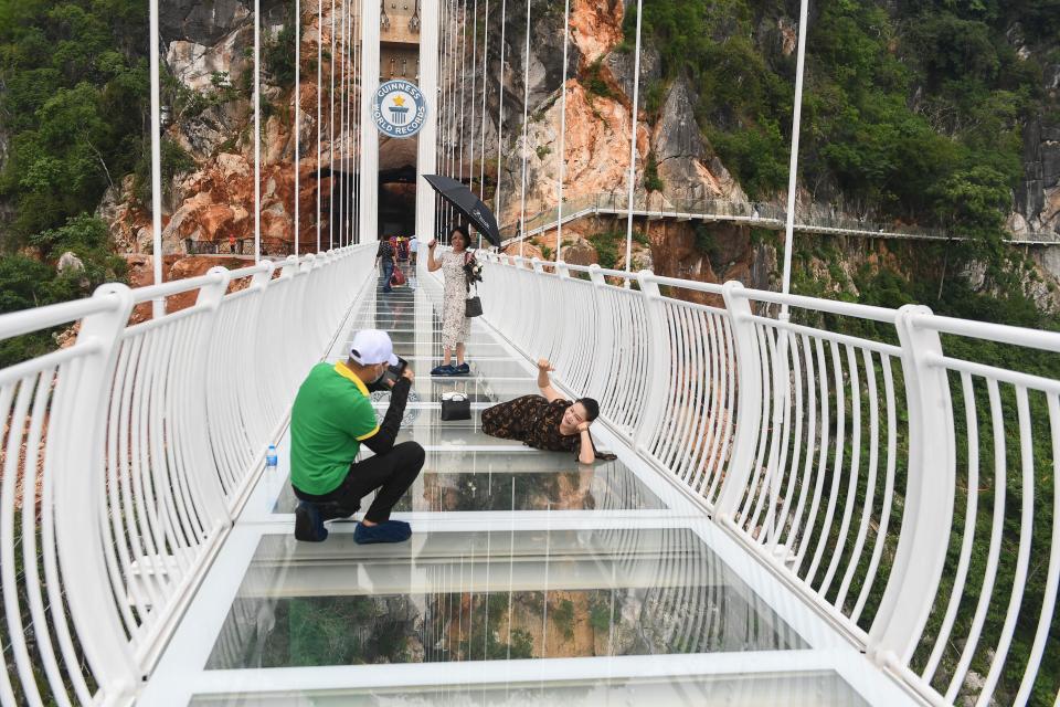 people take pictures on the Bach Long glass bridge in the Moc Chau district in Vietnam's Son La province