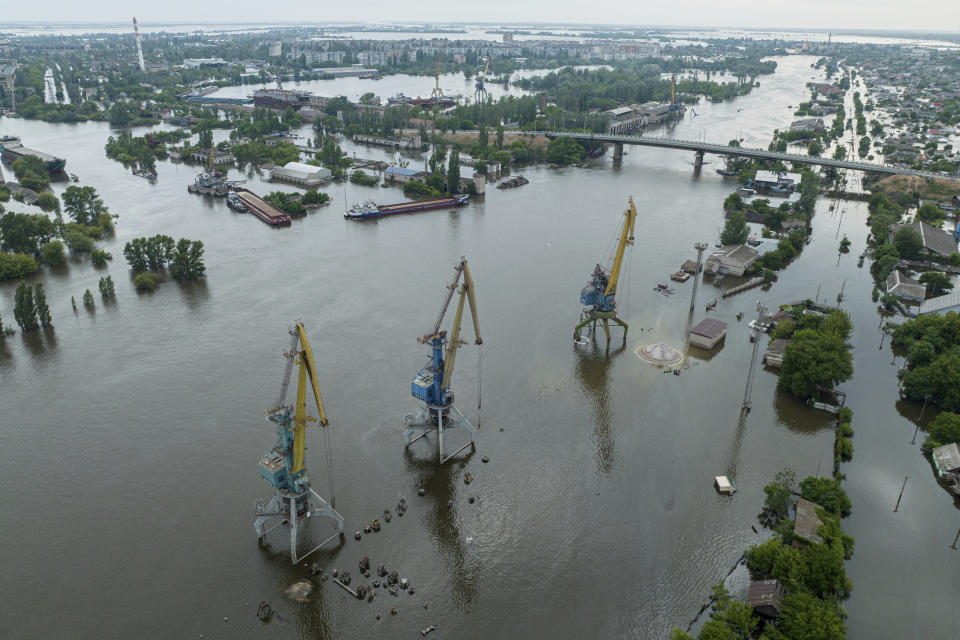 Streets and trade port are seen underwater and polluted by oil in the flooded Kherson, Ukraine, Saturday, June 10, 2023. The destruction of the Kakhovka Dam in southern Ukraine is swiftly evolving into long-term environmental catastrophe. It affects drinking water, food supplies and ecosystems reaching into the Black Sea. (AP Photo)