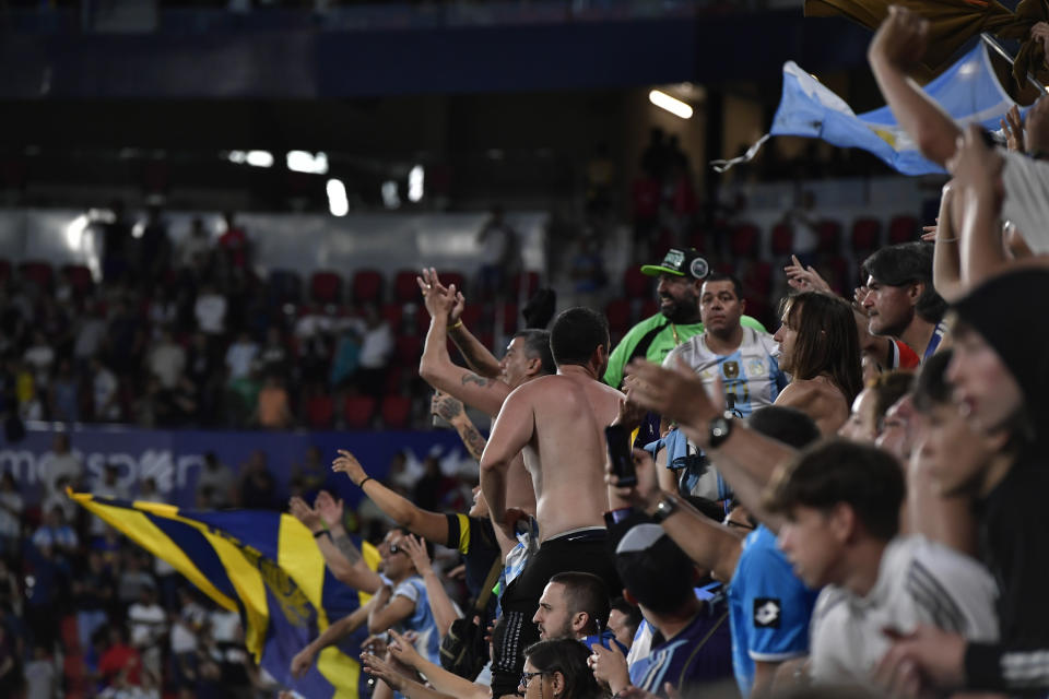 Argentina's fans celebrate their team's 5-0 win over Estonia, in a friendly soccer match at El Sadar stadium in Pamplona, northern Spain, Sunday, June 5, 2022. Argentina won 5-0 and Lionel Messi scored all five goals. (AP Photo/Alvaro Barrientos)